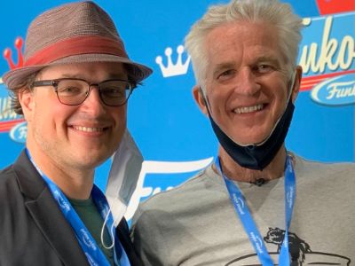 Both Boman Mark Rivera Modine and Matthew Modine are smiling for the camera as they have identity cards with them.